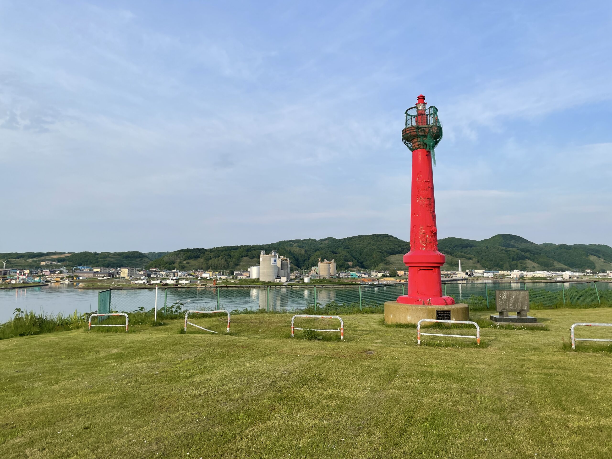 Der 'Rote Leuchtturm' mit dem Hafen von Rumoi im Hintergrund